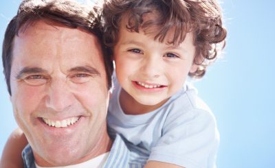 Close-up of a father with his son on his back